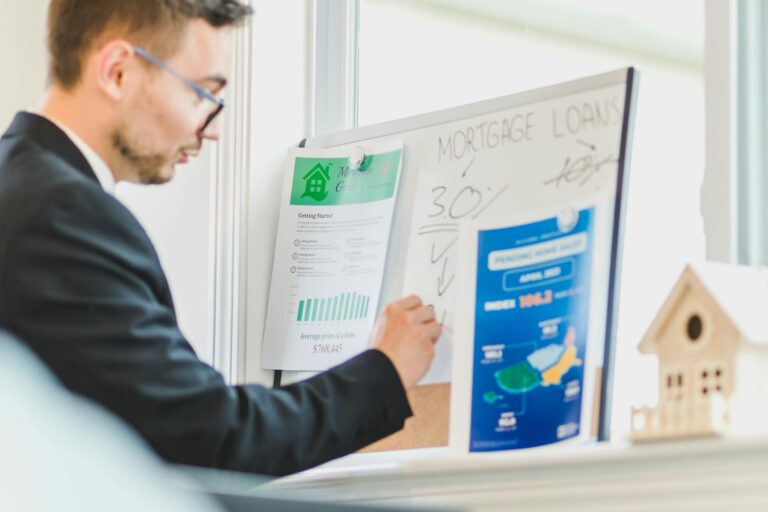 Real estate agent analyzing mortgage loan details on a whiteboard in an office setting.